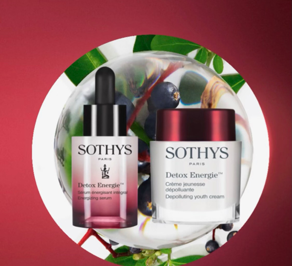 Two sothys skincare products, a serum and a cream, are displayed against a backdrop of mixed berries and hair color-inspired gradient from green to purplish hues. - K. Charles & Co. in San Antonio and Schertz, TX