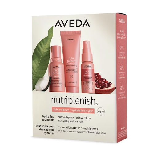 A product box of aveda nutriplenish featuring shampoo, conditioner, and leave-in conditioner with pomegranate and cotton plant decorations. - K. Charles & Co. in San Antonio and Schertz, TX