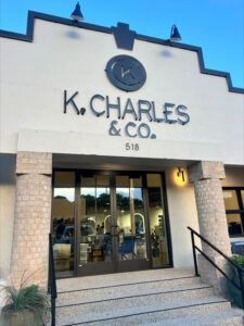 Front entrance of K. Charles & Co. at 518, showing double glass doors, brick columns, and the business name displayed above. - K. Charles & Co. in San Antonio, TX